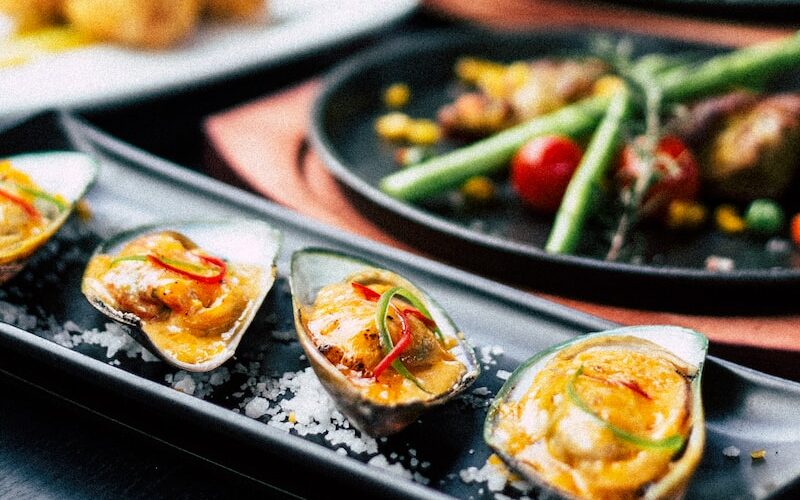 buttered muscles served on black plate