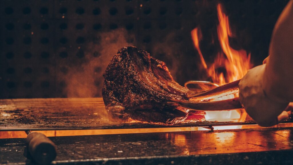 person barbecuing meat