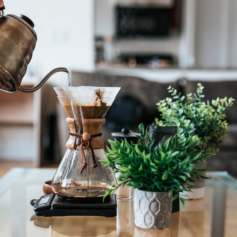person pouring coffee ion jar