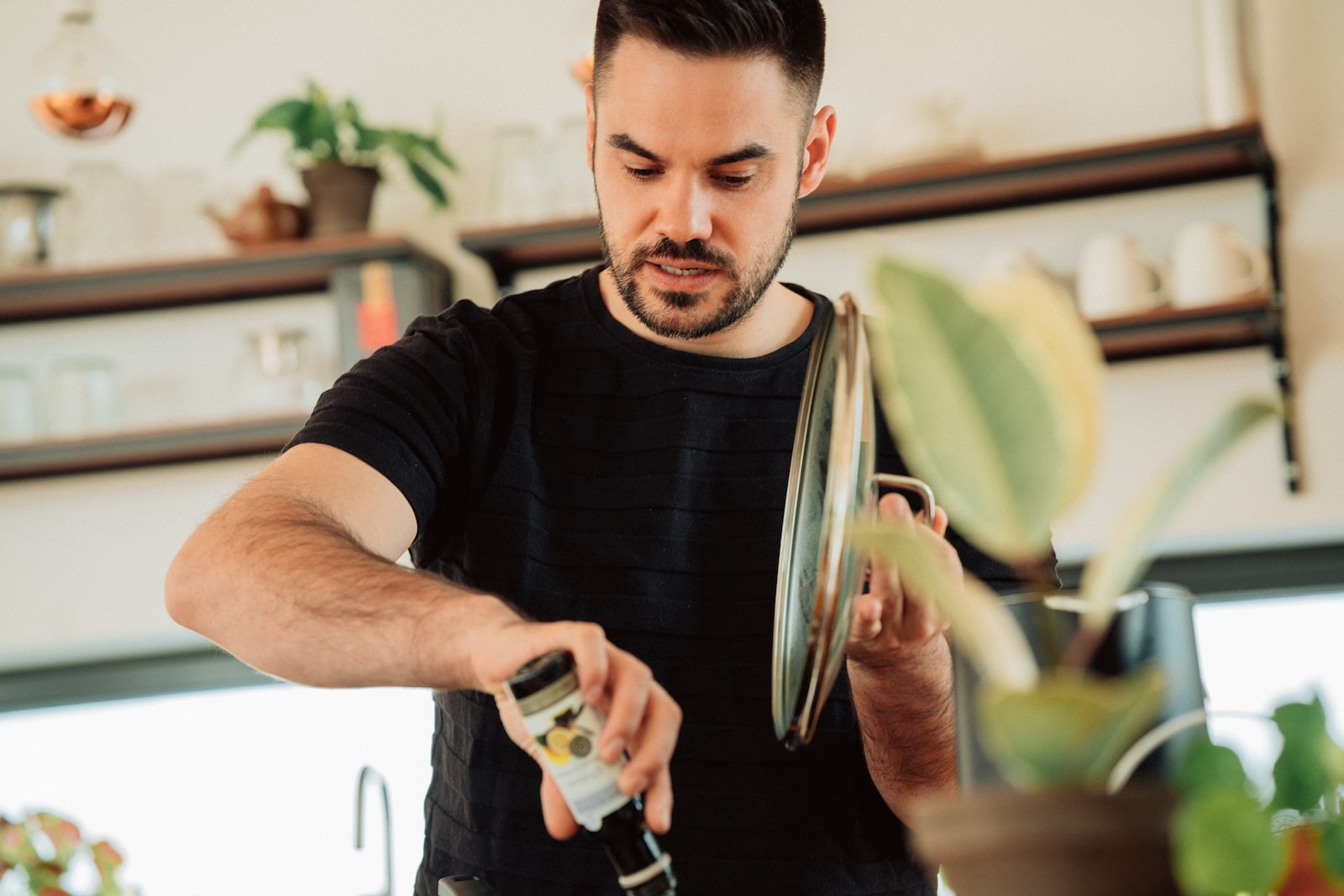 Photo by Malte Helmhold man in black crew neck t-shirt holding silver and black hair clipper