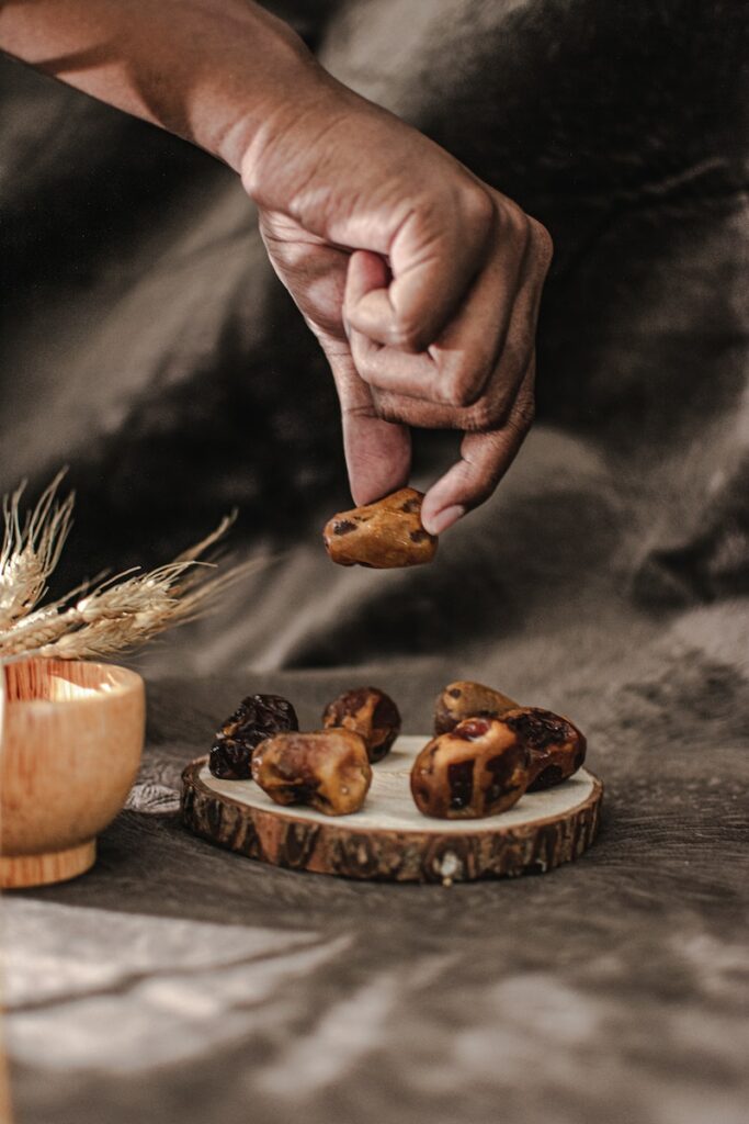 a person reaching for some food on a table