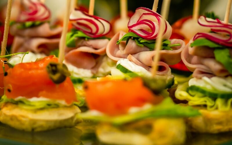 a platter of finger foods with toothpicks in the middle
