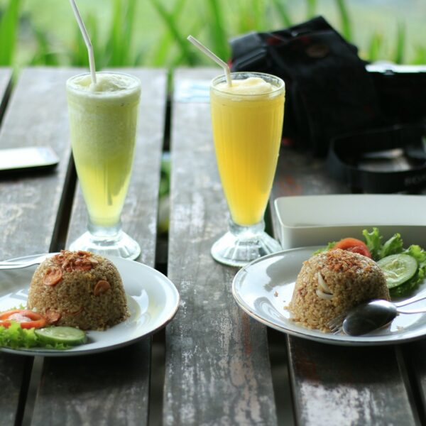 fried rice and glass of juices on table