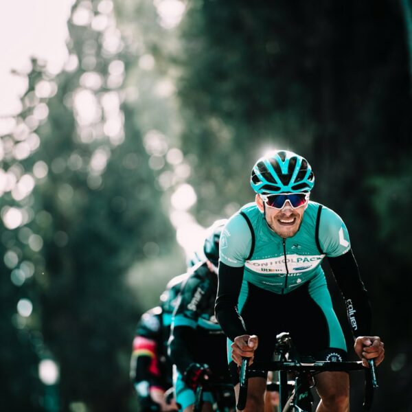 shallow focus of man riding bike during daytime