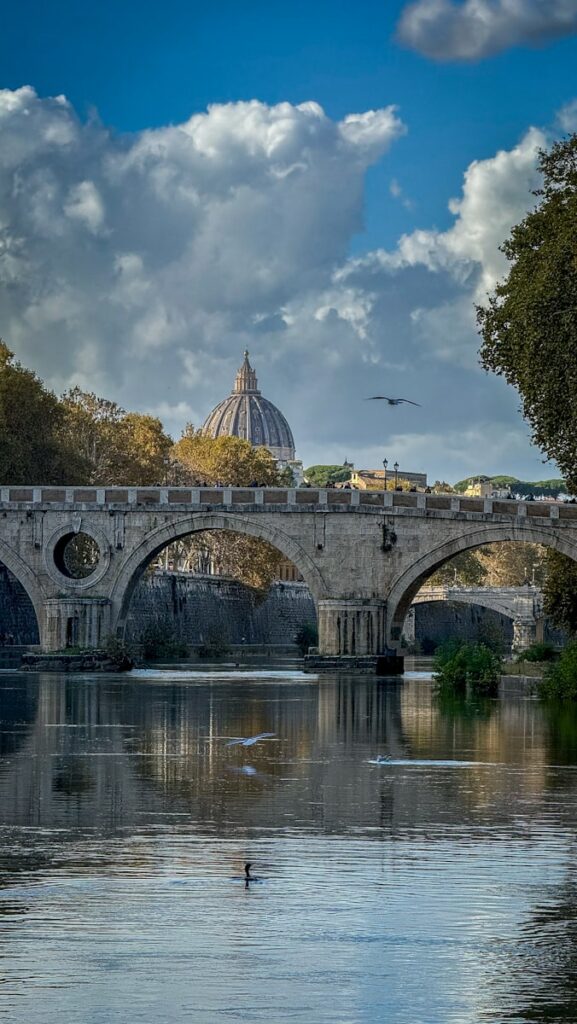 A bridge over a body of water with a building in the background
