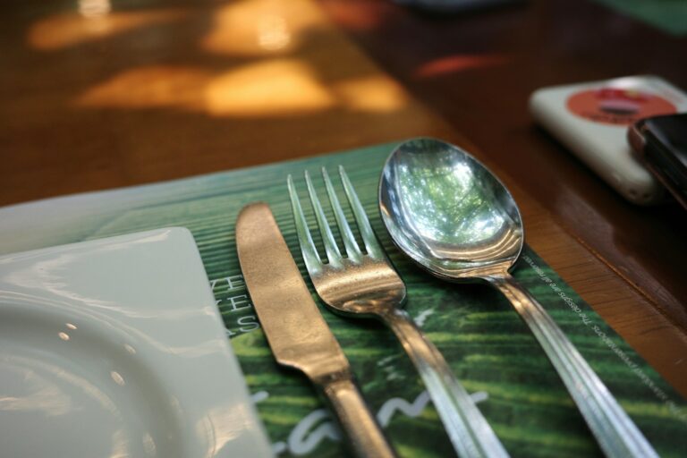 a close up of a fork and a spoon on a table