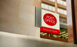 a post office sign on the side of a building