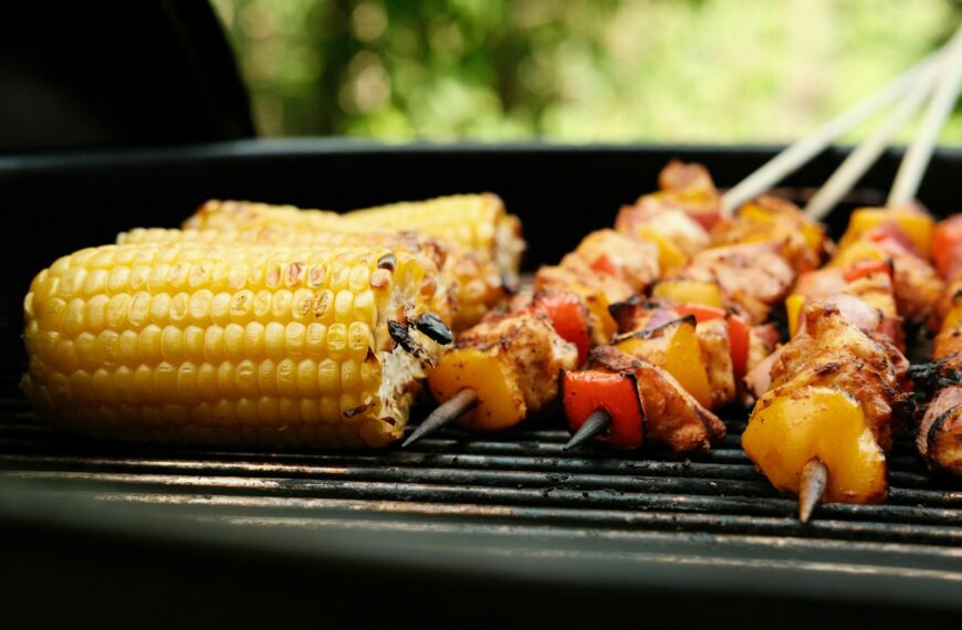 corn on the cob and meat on the grill